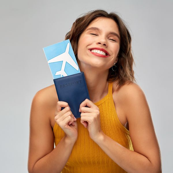 Happy Woman with Air Ticket and Passport