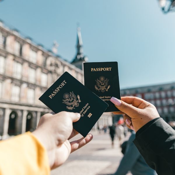 showing US passports on street on sunny day